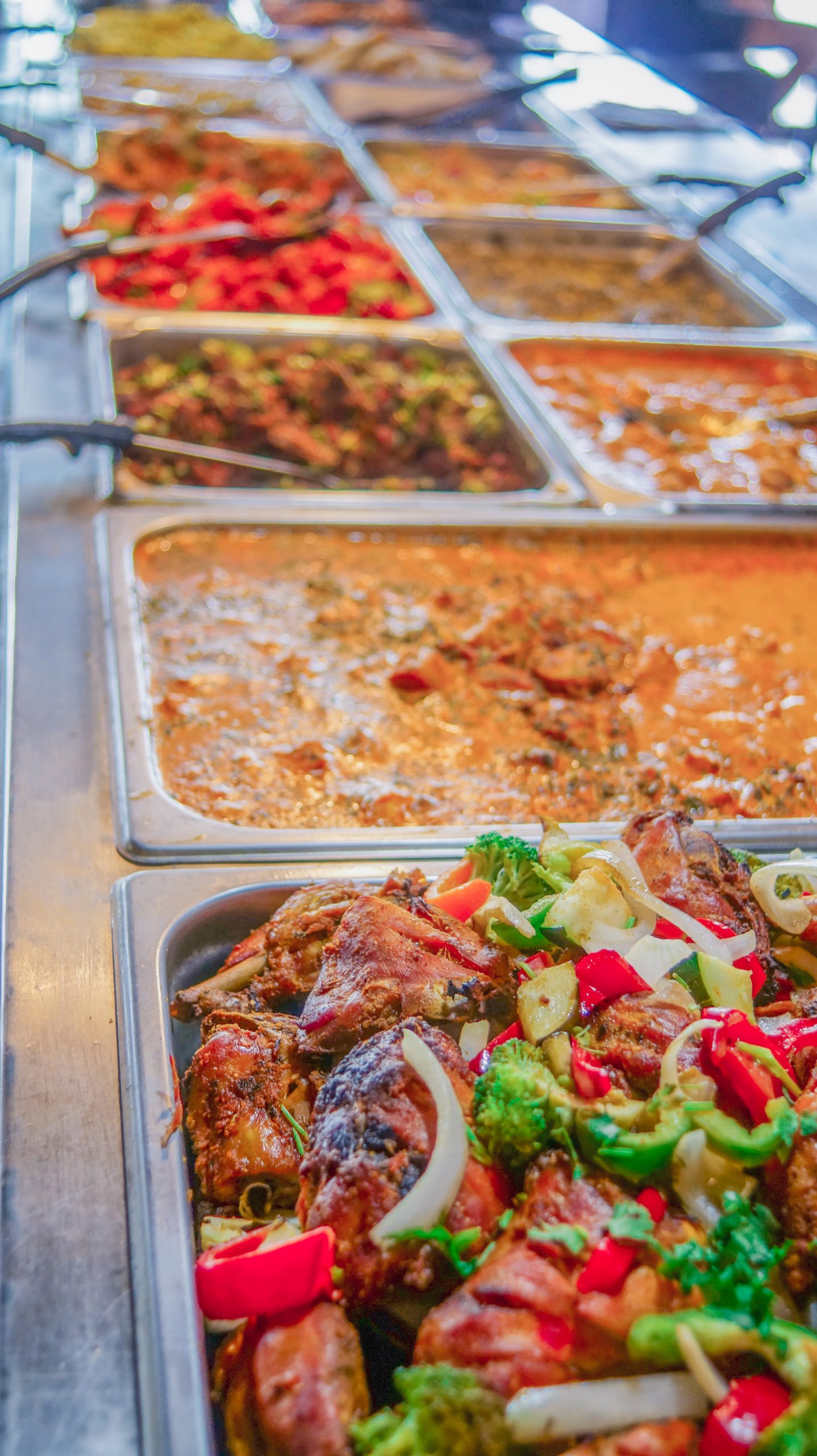 Tandoori chicken, tikka masala, and assorted curries on the buffet line